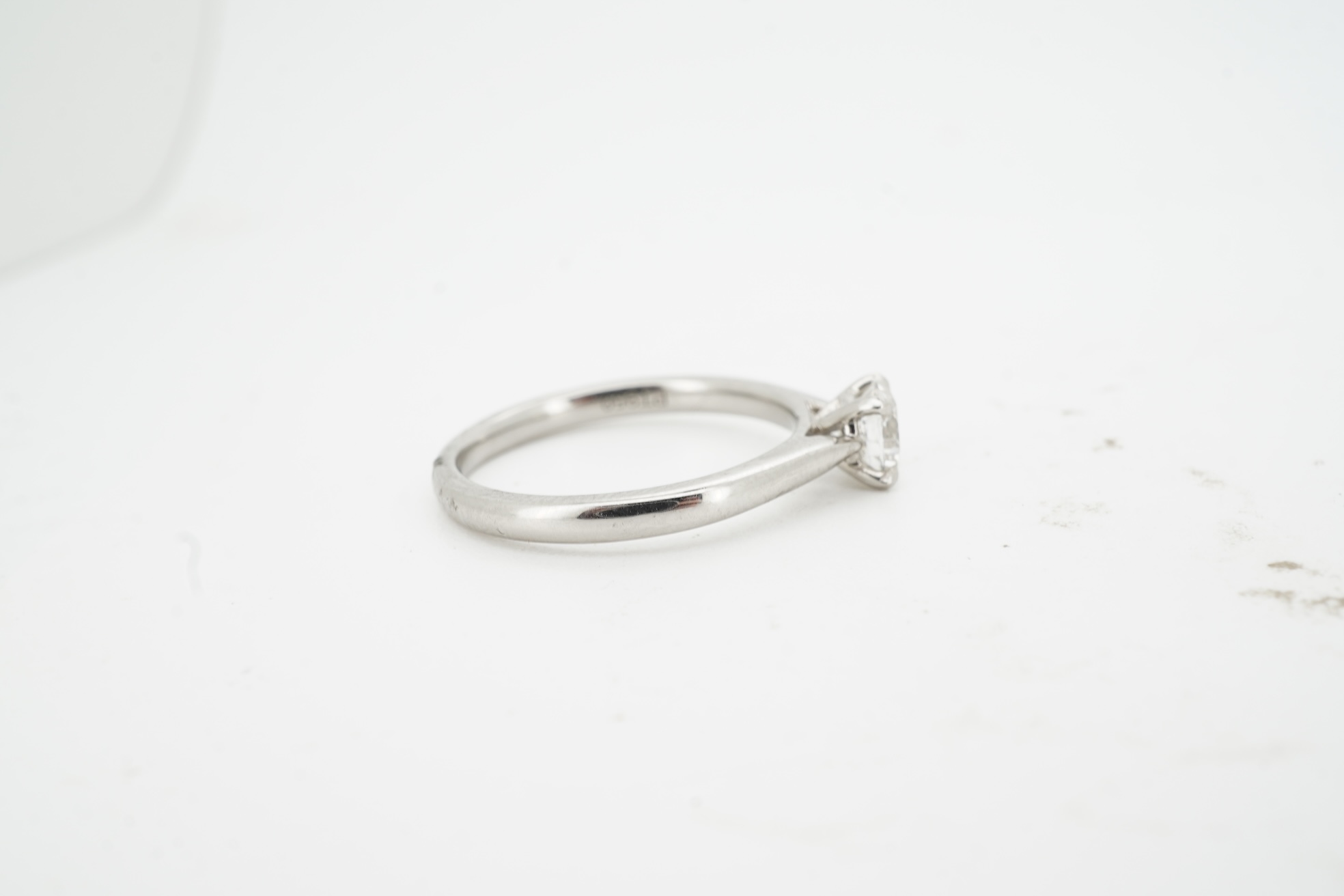 A diamond ring, claw-set with a brilliant-cut diamond weighing approximately 0.57 carats, mounted in platinum, size M, British hallmarks, gross weight approximately 3 grams